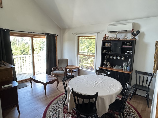30 Steamboat Rd, Swans Island, ME 04685 - dining area featuring lofted ceiling, wood finished floors, and an AC wall unit