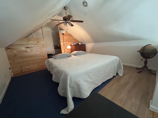 30 Steamboat Rd, Swans Island, ME 04685 - bedroom with wood walls, baseboards, ceiling fan, wood finished floors, and lofted ceiling