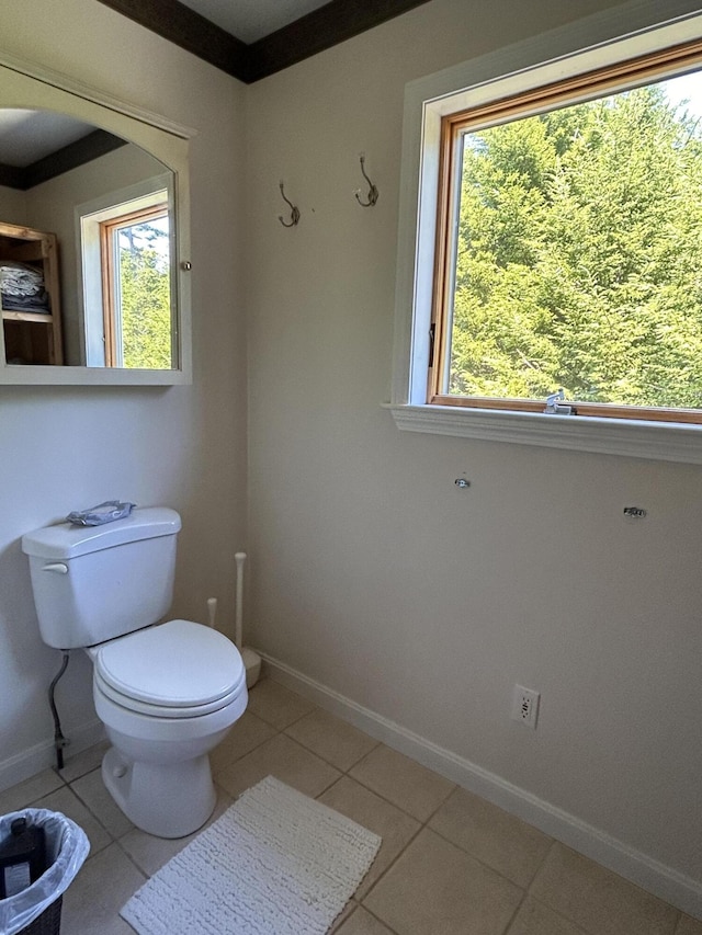 30 Steamboat Rd, Swans Island, ME 04685 - bathroom featuring baseboards, toilet, a healthy amount of sunlight, and tile patterned flooring