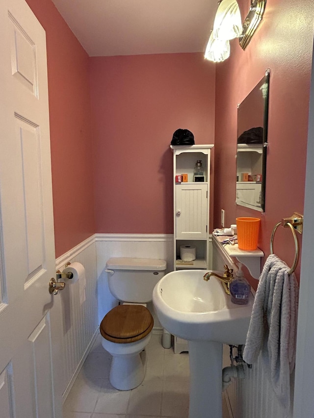 30 Steamboat Rd, Swans Island, ME 04685 - bathroom with tile patterned floors, toilet, and wainscoting