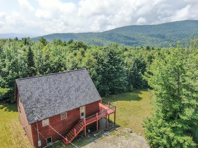 birds eye view of property featuring a mountain view and a view of trees