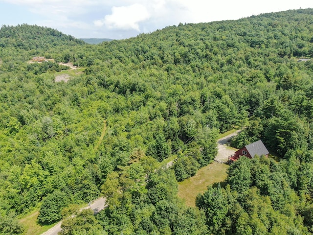 birds eye view of property featuring a wooded view