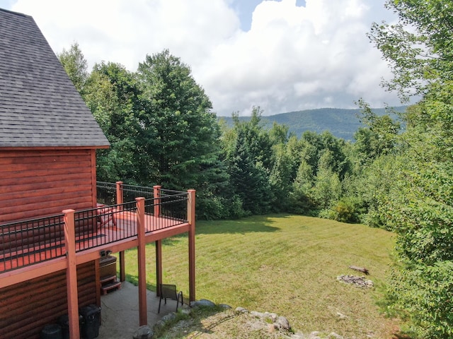 view of yard featuring a deck with mountain view