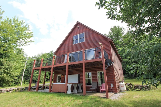 rear view of house featuring a patio, a yard, and log veneer siding