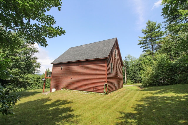 view of side of home featuring log veneer siding, a lawn, and roof with shingles