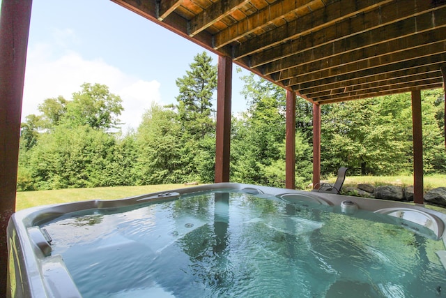 view of swimming pool featuring a hot tub