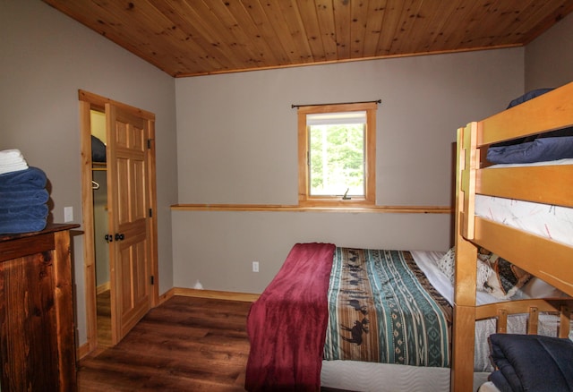 bedroom with crown molding, wood ceiling, and dark hardwood / wood-style floors