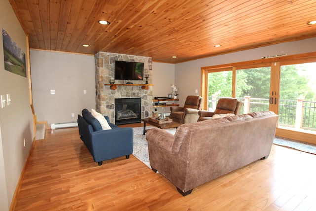 living room featuring light wood-type flooring, baseboard heating, wood ceiling, and a stone fireplace