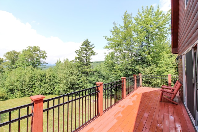 wooden deck with a lawn