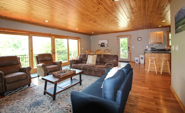 living room with recessed lighting, wooden ceiling, baseboards, and wood finished floors