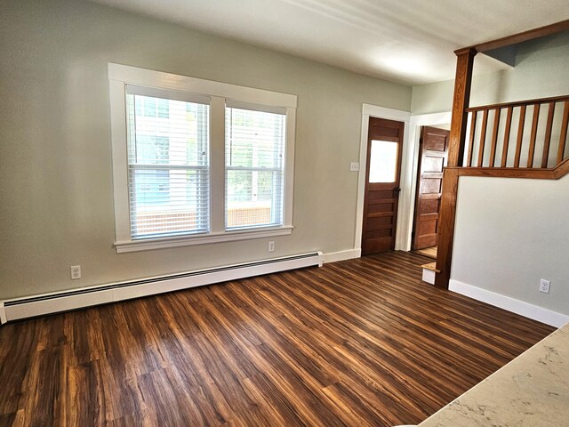 entrance foyer featuring baseboard heating, baseboards, and wood finished floors