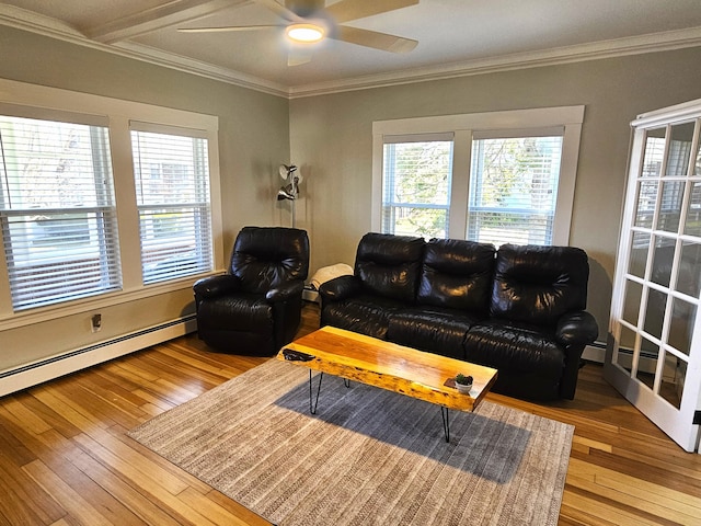 living area with ceiling fan, a baseboard heating unit, hardwood / wood-style floors, and crown molding