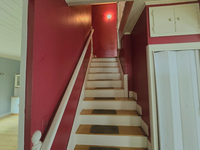 stairs with wood-type flooring