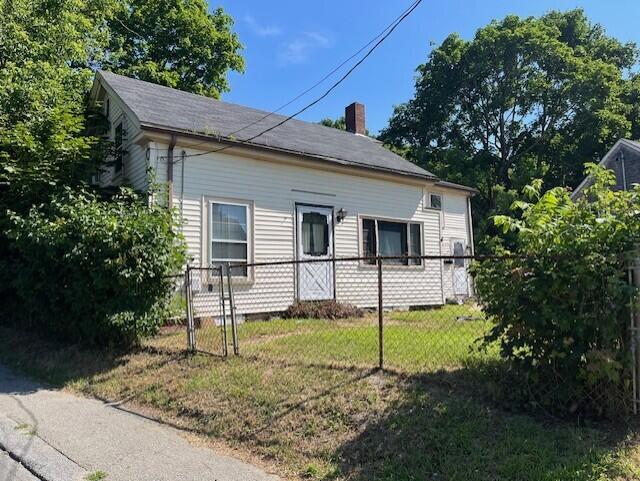 view of side of home featuring a lawn