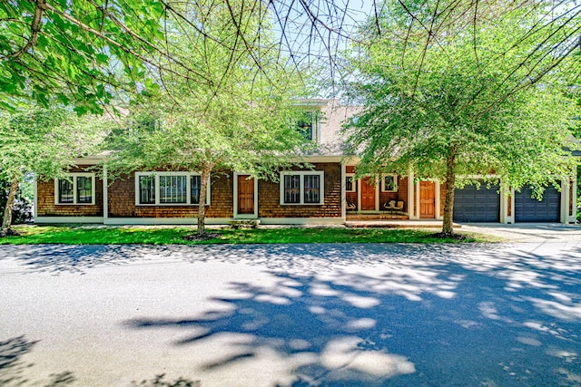 obstructed view of property with a garage