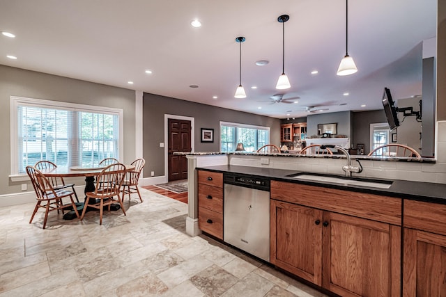 kitchen featuring dishwasher, sink, pendant lighting, and ceiling fan