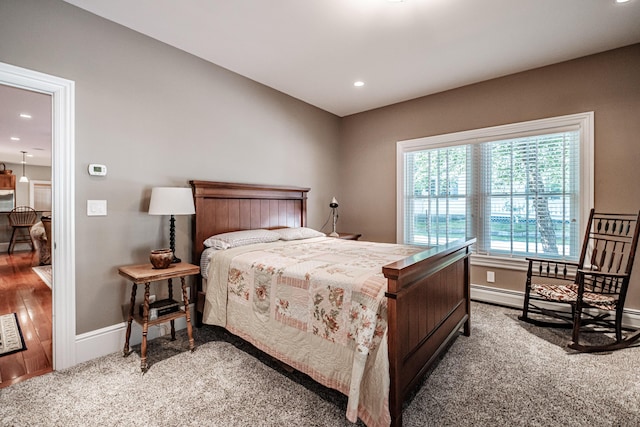 carpeted bedroom with a baseboard heating unit