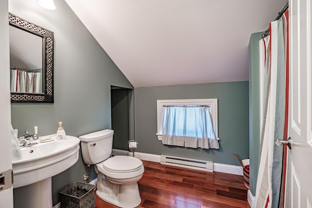 bathroom with toilet, sink, vaulted ceiling, hardwood / wood-style floors, and a baseboard heating unit