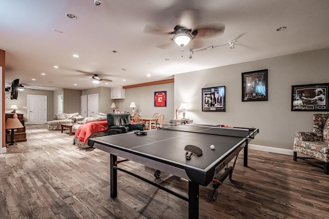 recreation room featuring wood-type flooring, track lighting, and ceiling fan