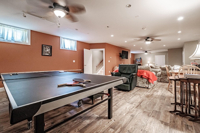 rec room with ceiling fan and light hardwood / wood-style flooring