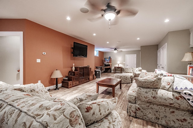 living room featuring ceiling fan and light hardwood / wood-style floors