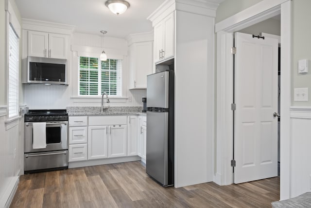 kitchen with white cabinetry, appliances with stainless steel finishes, and sink