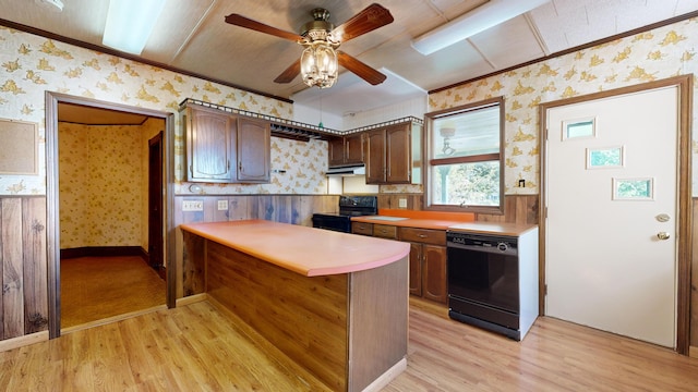 kitchen with ceiling fan, wood walls, dark brown cabinets, black appliances, and light wood-type flooring