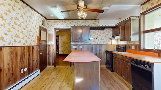 kitchen featuring a baseboard radiator, light wood-type flooring, wooden walls, and black appliances