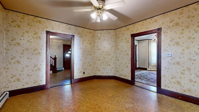 empty room featuring ceiling fan and a baseboard heating unit