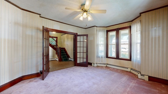 spare room featuring ceiling fan, carpet floors, french doors, and crown molding