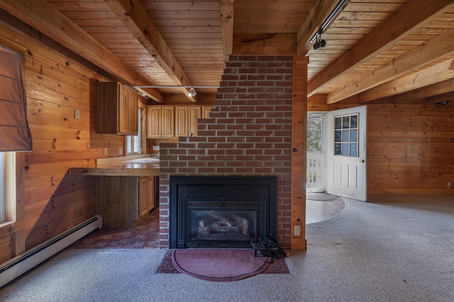 interior space featuring beam ceiling, rail lighting, baseboard heating, wood ceiling, and wooden walls