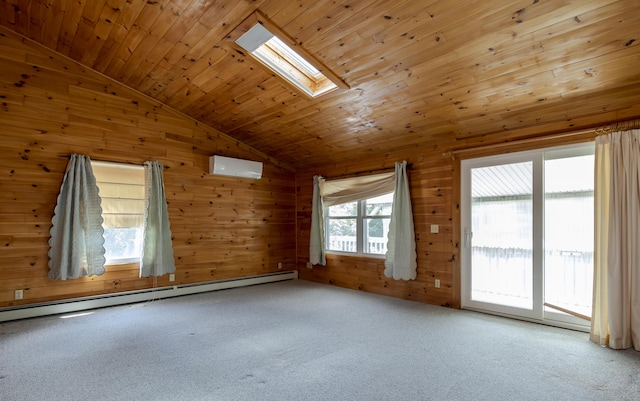 carpeted spare room featuring a wall unit AC, lofted ceiling with skylight, wood ceiling, a baseboard radiator, and wood walls