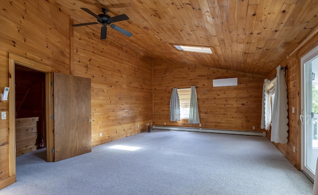 spare room with vaulted ceiling with skylight, wooden ceiling, a baseboard radiator, and carpet