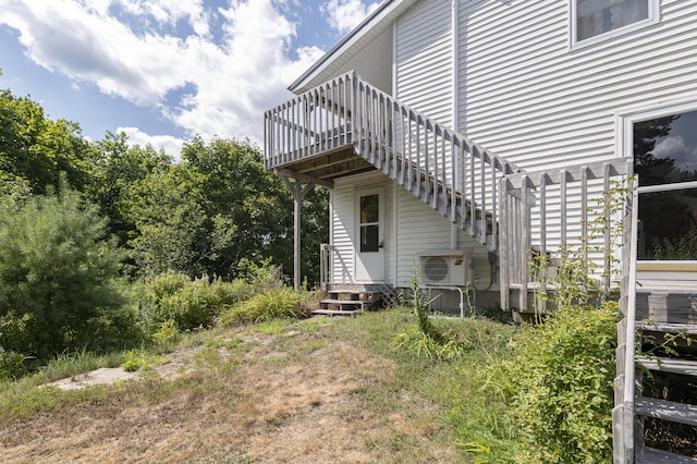 exterior space with entry steps, ac unit, and a pergola