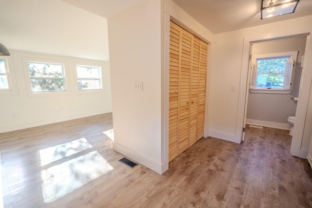 hallway with light hardwood / wood-style flooring