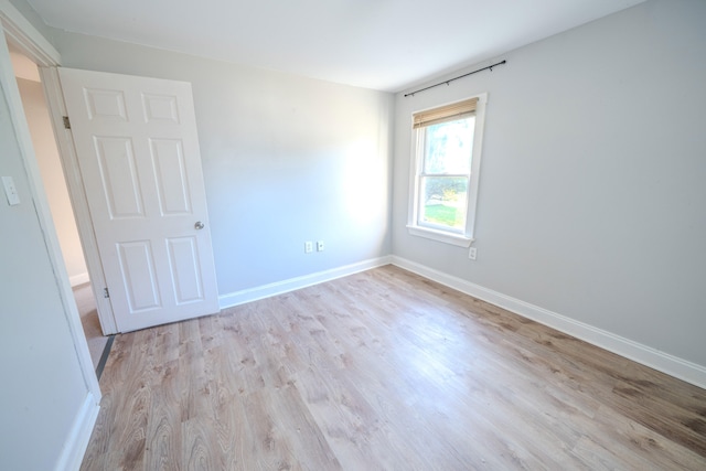 unfurnished room with light hardwood / wood-style flooring