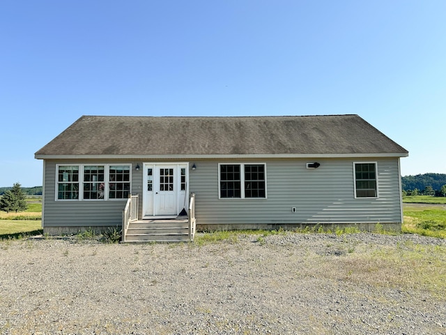 view of front of home featuring roof with shingles