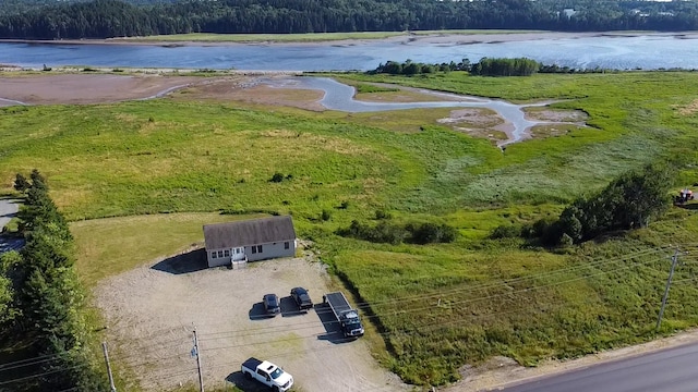 aerial view featuring a forest view and a water view