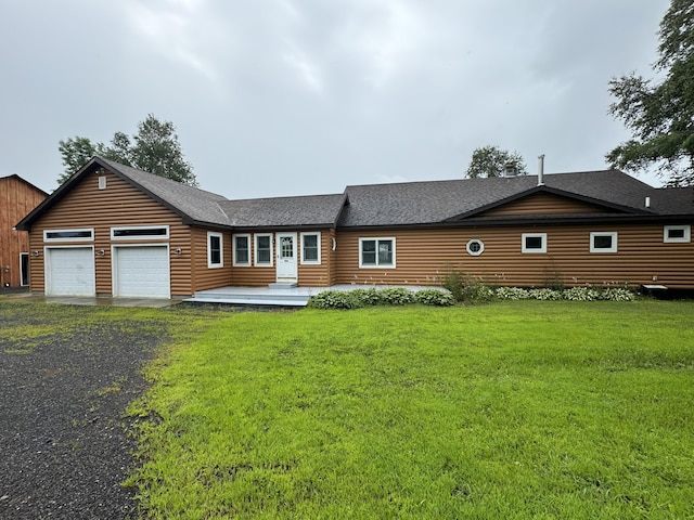 ranch-style home with a garage and a front lawn