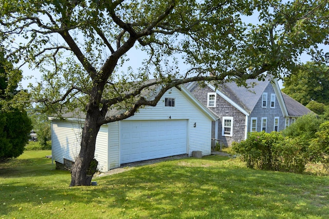 view of property exterior featuring an outdoor structure, roof with shingles, and a lawn