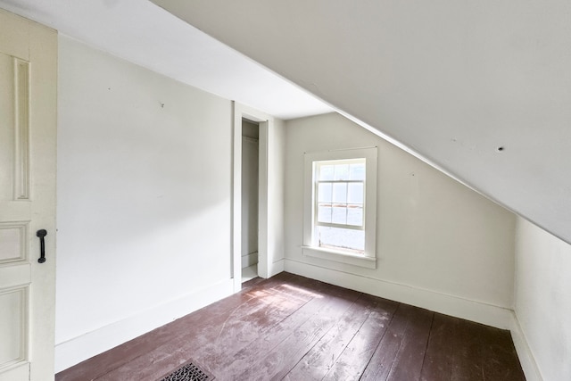 additional living space featuring hardwood / wood-style floors