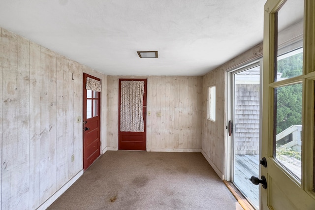 spare room with plenty of natural light and carpet