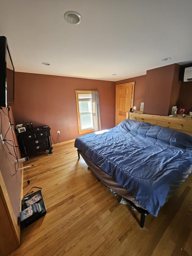 bedroom with hardwood / wood-style floors