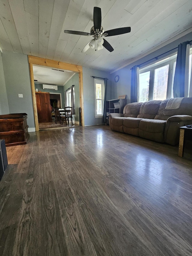 unfurnished living room with dark wood-type flooring, ceiling fan, an AC wall unit, and wooden ceiling