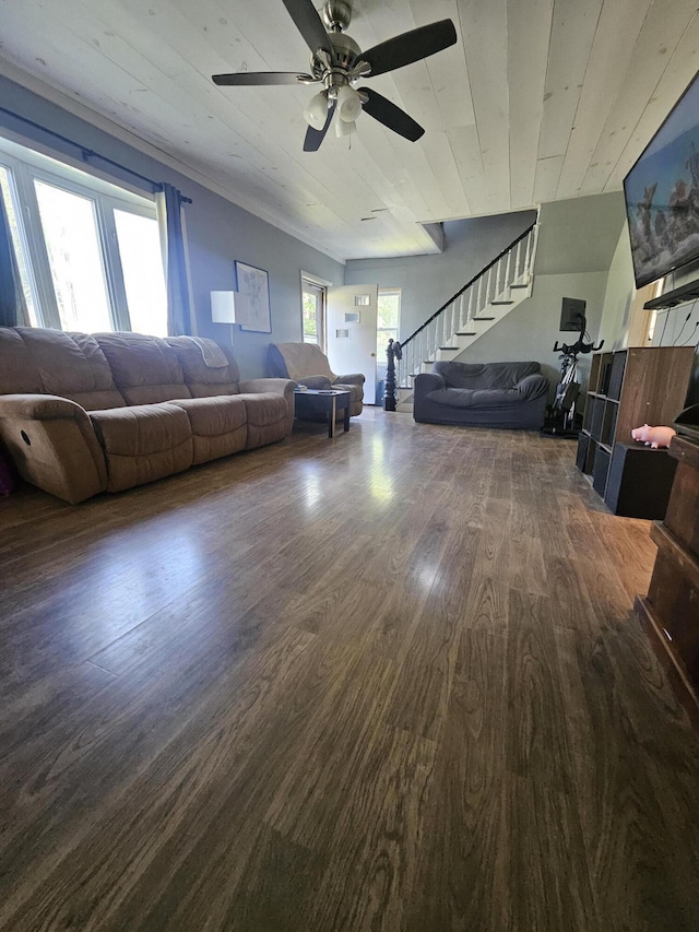 unfurnished living room featuring vaulted ceiling, dark wood-type flooring, wooden ceiling, and ceiling fan