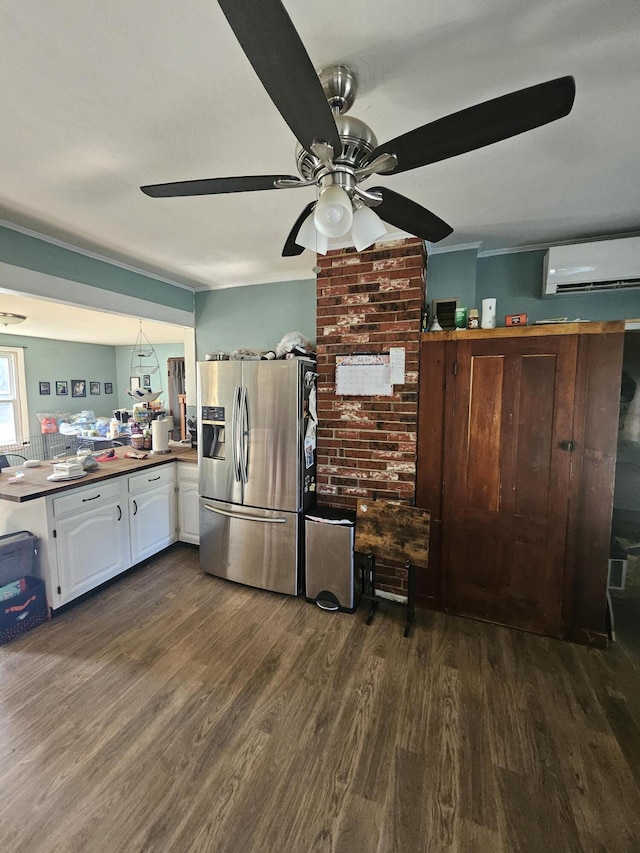 kitchen with stainless steel refrigerator with ice dispenser, white cabinetry, dark hardwood / wood-style flooring, a wall unit AC, and ceiling fan