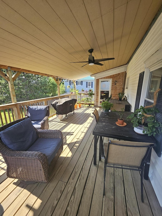 wooden terrace featuring ceiling fan