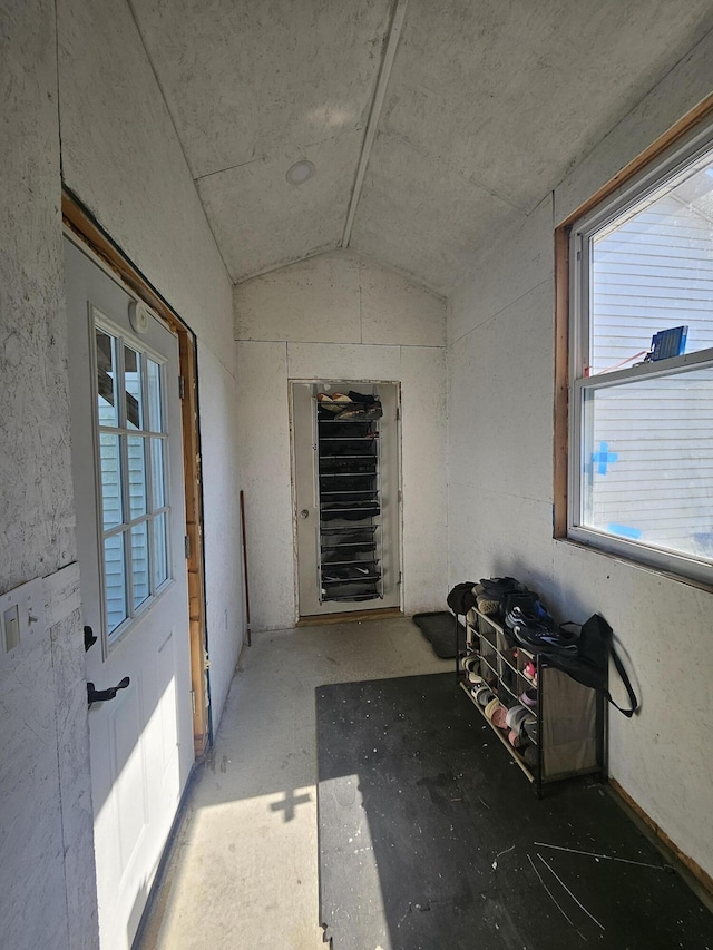 hall featuring lofted ceiling