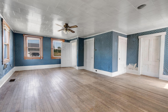 empty room with light hardwood / wood-style flooring and ceiling fan