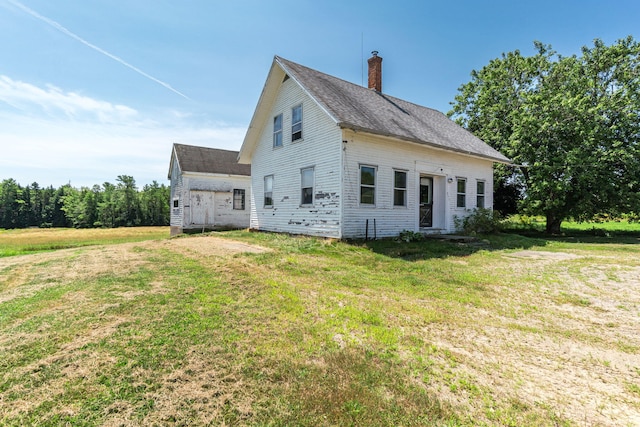 back of house with a yard